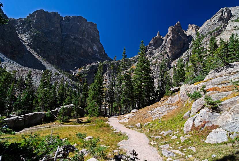 trail leading through grey crags on emerald lake hike in rocky mountain national park