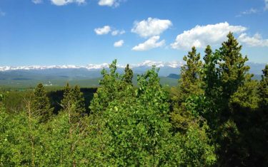 snow capped front range mountains of colorado from panorama at golden gate canyon state park along raccoon trail hike
